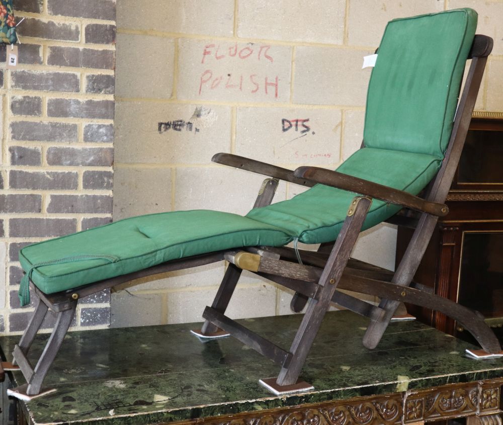 A teak garden steamer chair with cushion